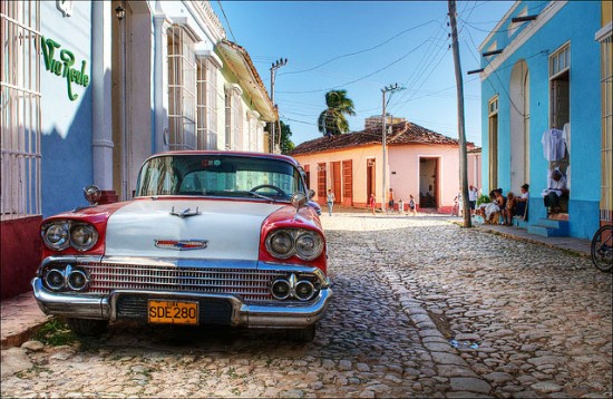 A gorgeous vintage car parked in the cobblestoned streets of Trinidad Cuba